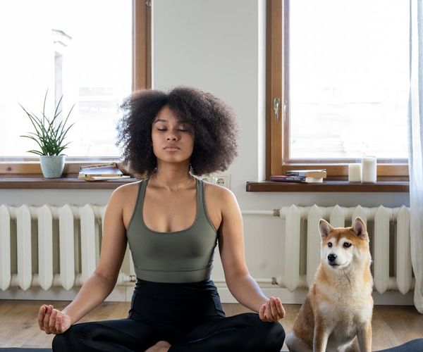 A serene setting with a yoga mat, candles, and soft lighting.