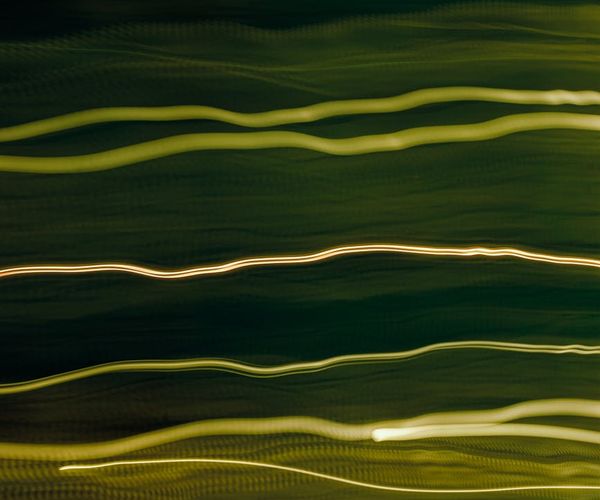 Dynamic abstract lines of light flowing upwards, symbolizing energy.